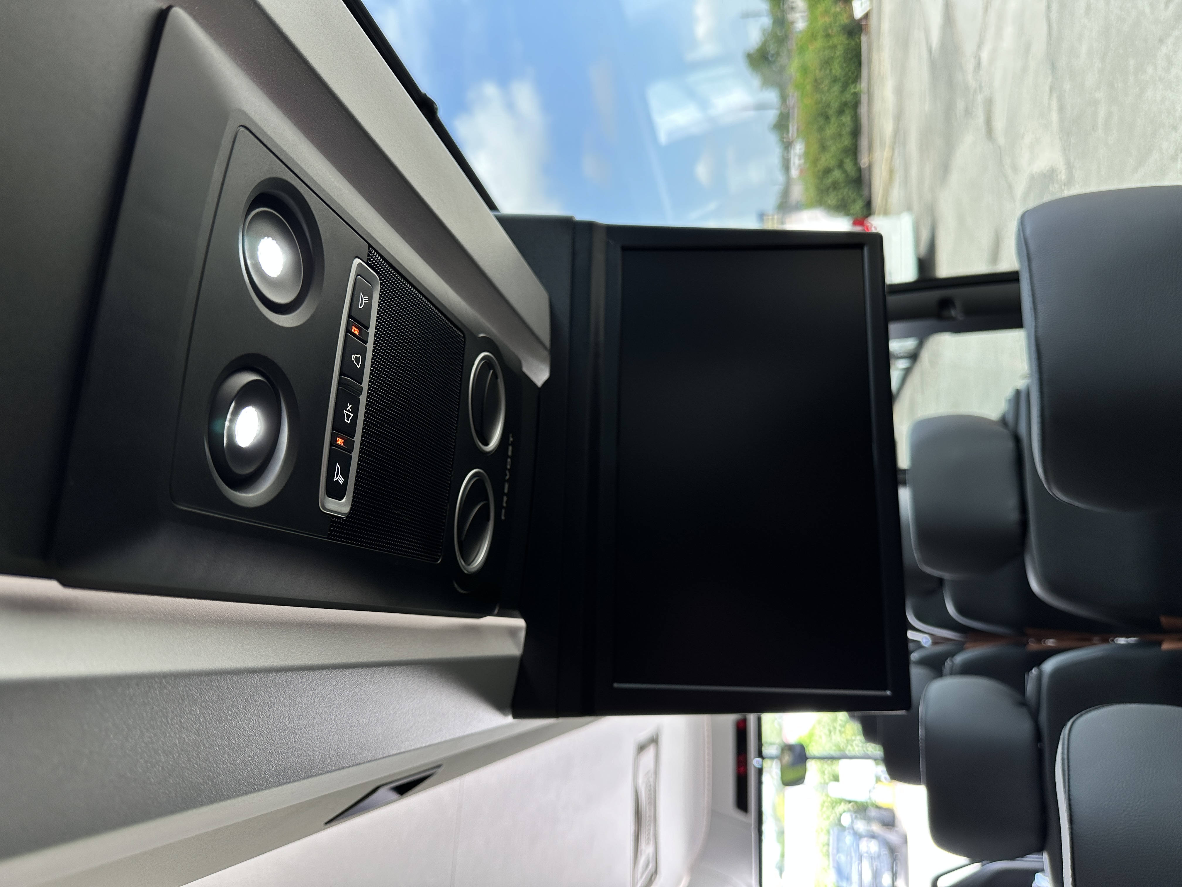 Overhead TV screen and LED reading lights on charter motor coach
